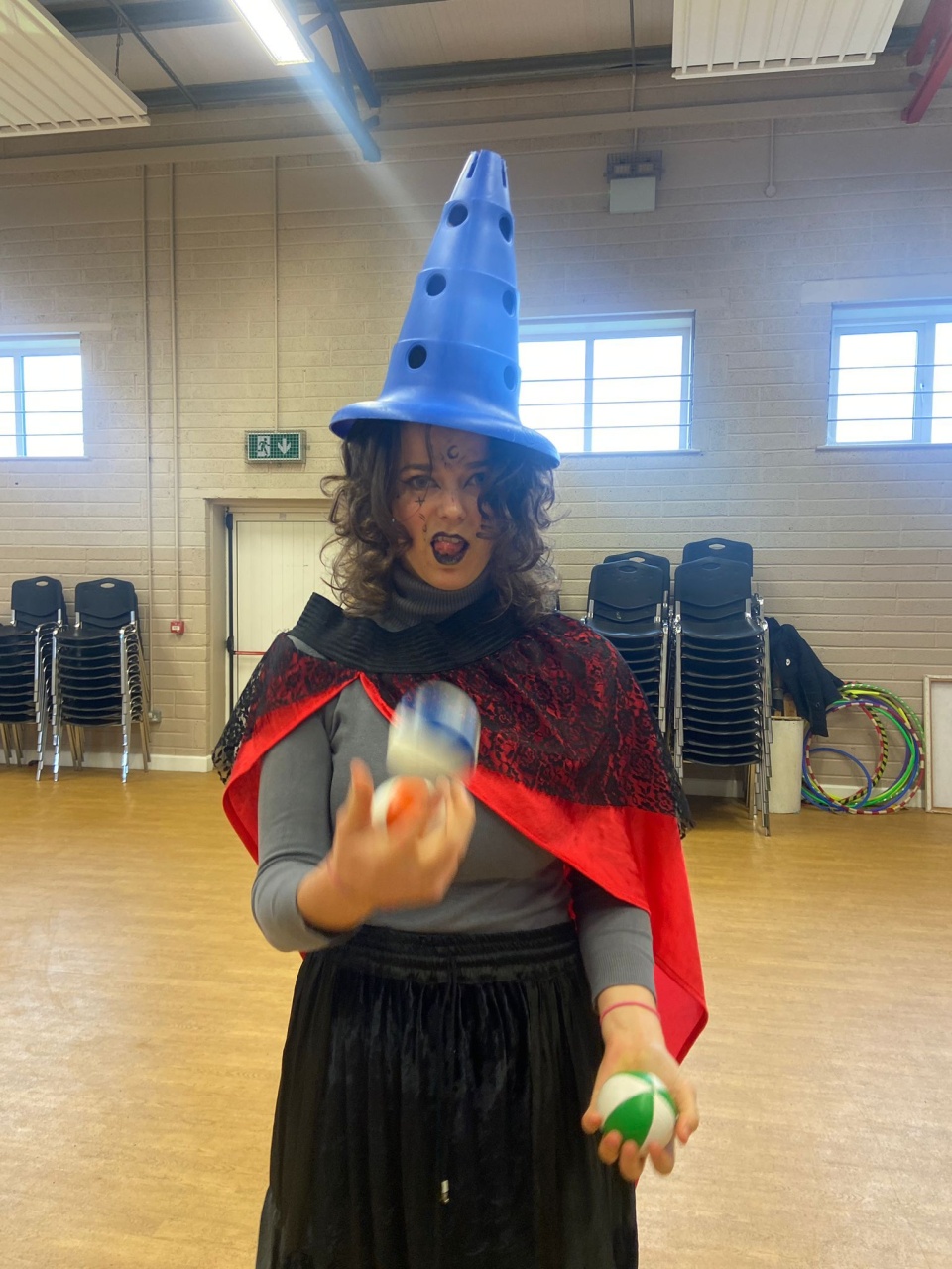 Elisa dressed up as witch practicing some juggling before class.